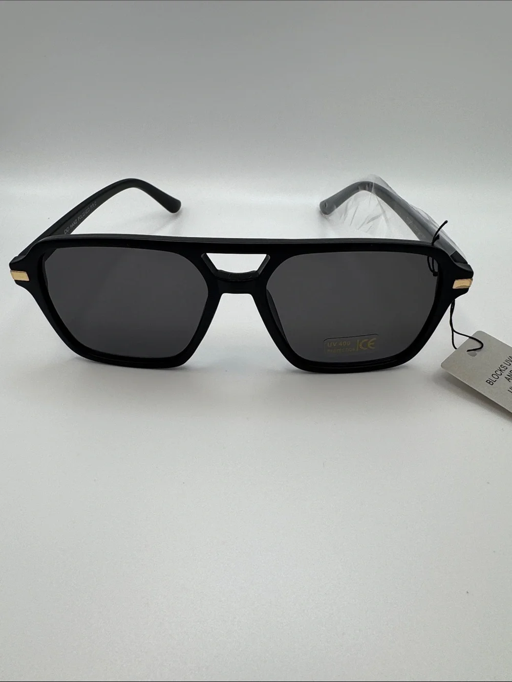 Black Sunglasses with Dark Lenses and Gold Accents